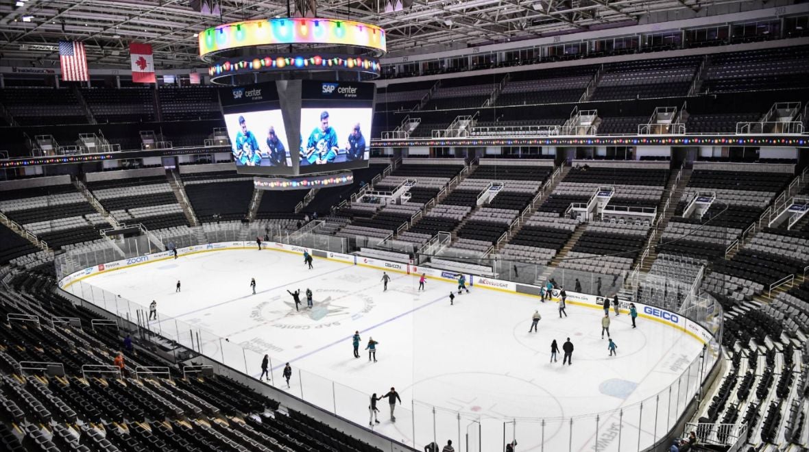 Sharks Ice Rink Holiday Event with holiday lights around the jumbotron